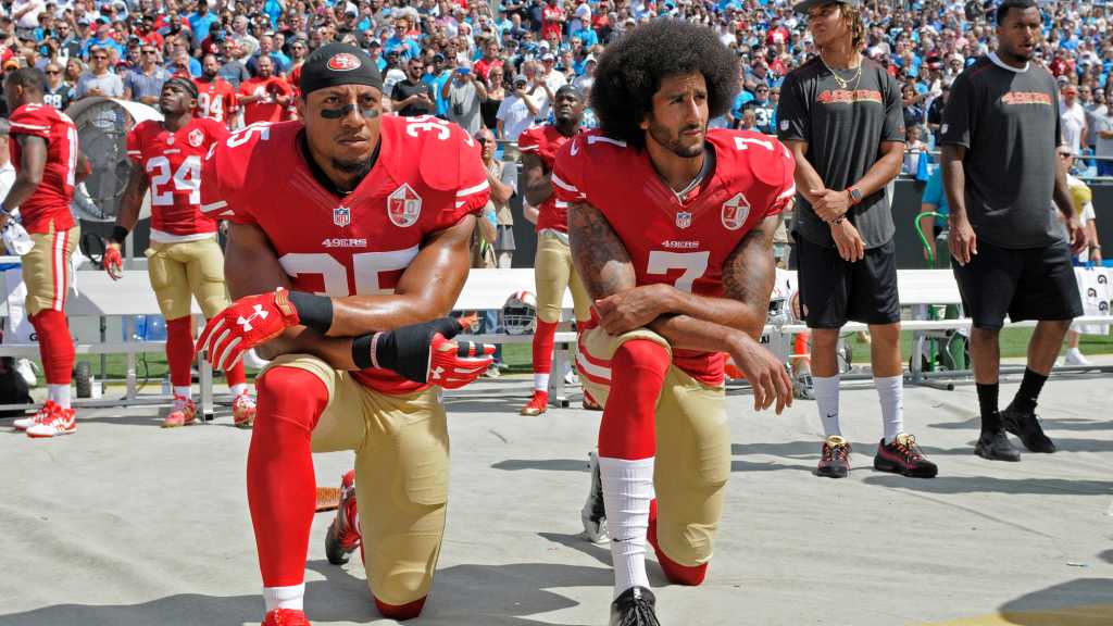 San Francisco 49ers' Colin Kaepernick (7) and Eric Reid (35) kneel during the national anthem before an NFL football game against the Carolina Panthers in Charlotte, N.C., Sunday, Sept. 18, 2016. (AP Photo/Mike McCarn)