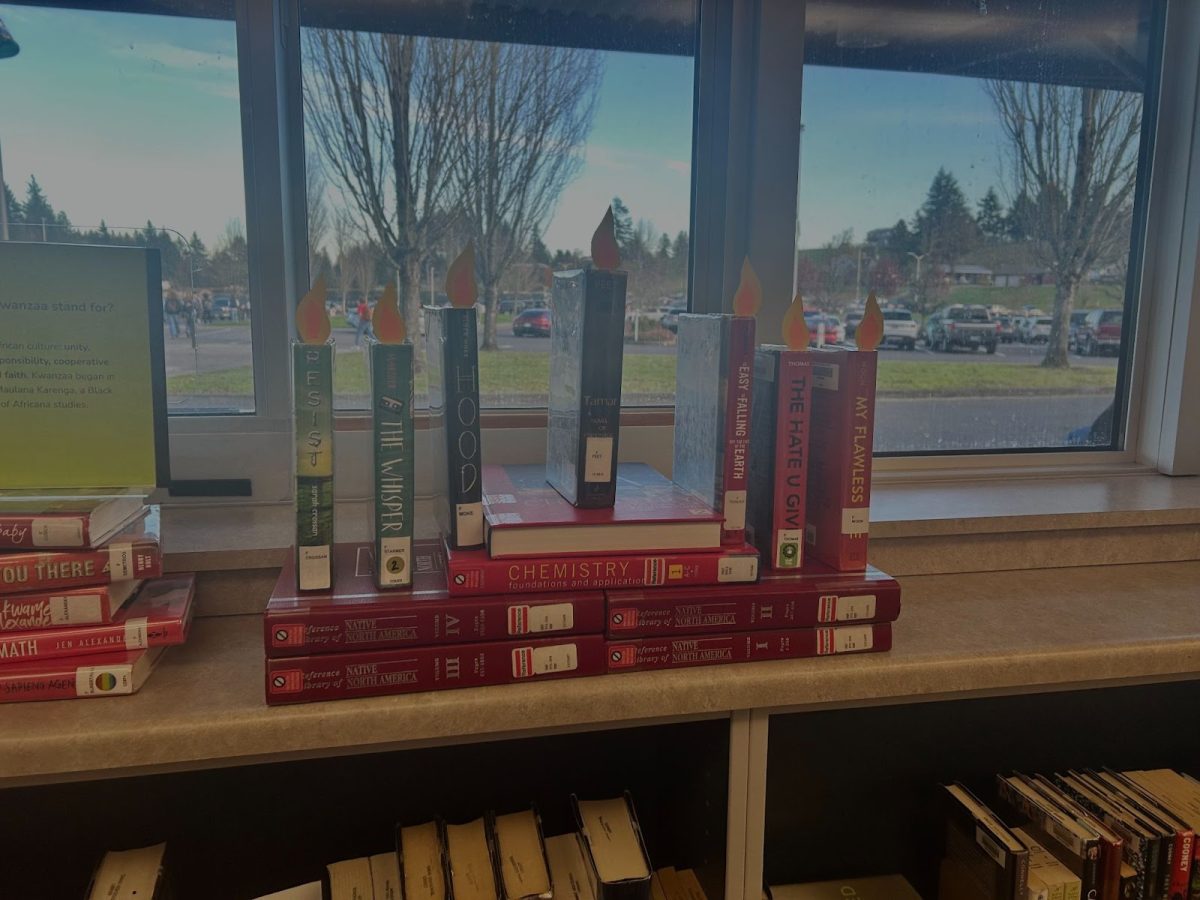 Display books in the CHS Library shaped like a kinara in honor of Kwanzaa
