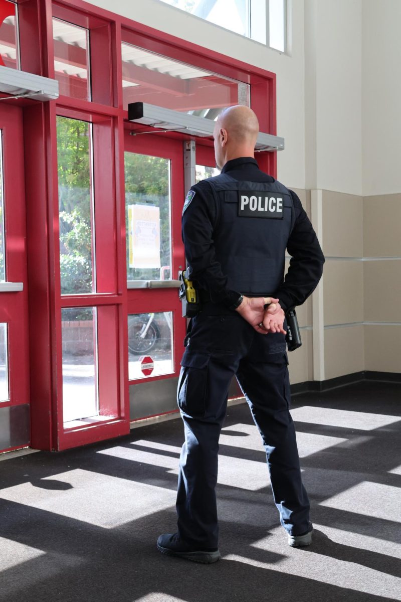 A Student Resource Officer stands guard at the entrance to CHS