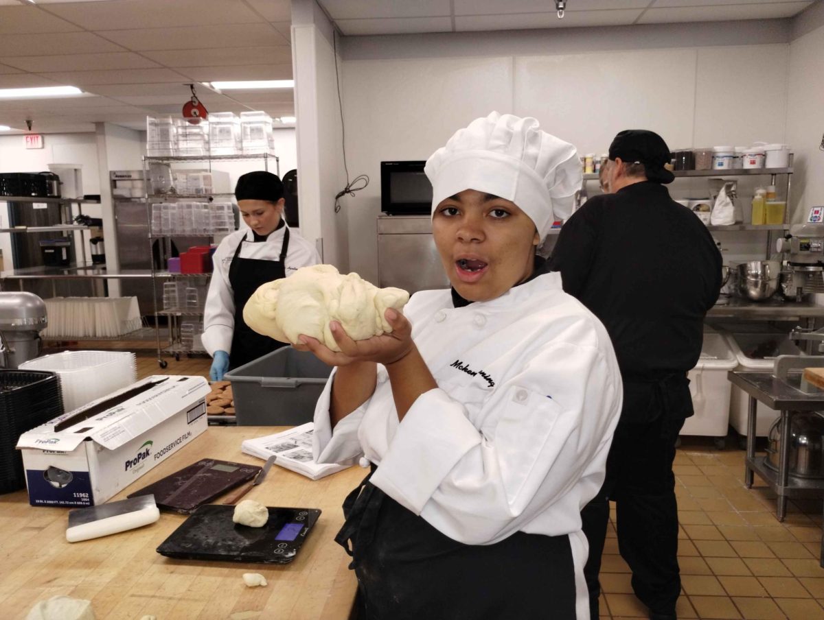 Culinary student McKena Terpening holding homemade dough