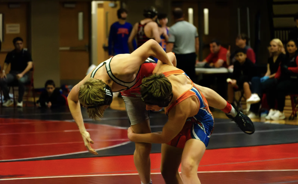 A JV Camas player flips a Ridgefield player