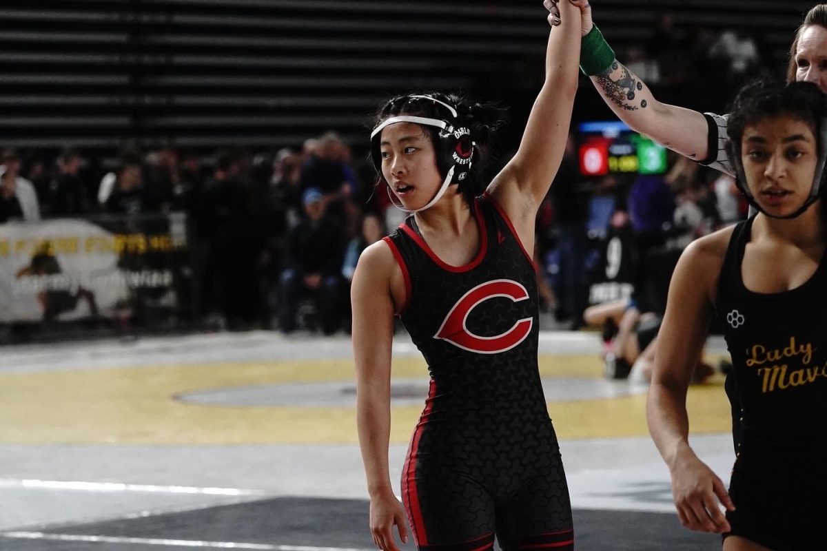 Jasmine Cha looks to her coaches after getting the win on a match (courtesy of Kim Collier)
