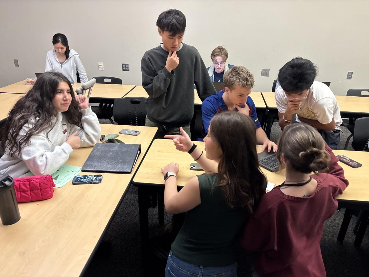 Investment Club members discuss the stock market during a meeting