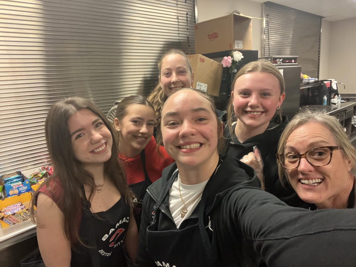Lisa Schnieder poses with concessions students after a busy event
