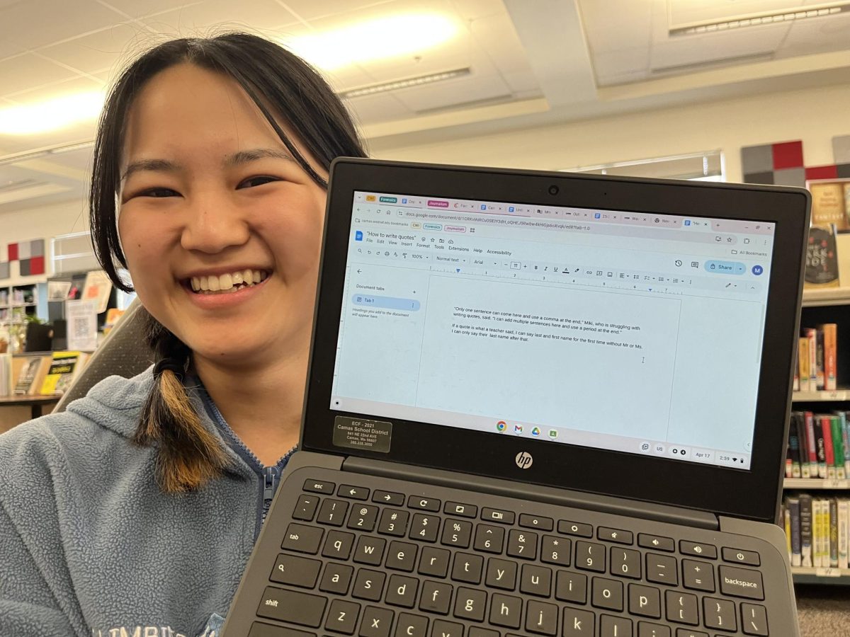 Miki Shibata showing her typed notes on an informal lesson by a peer about writing quotes in the journalistic style
